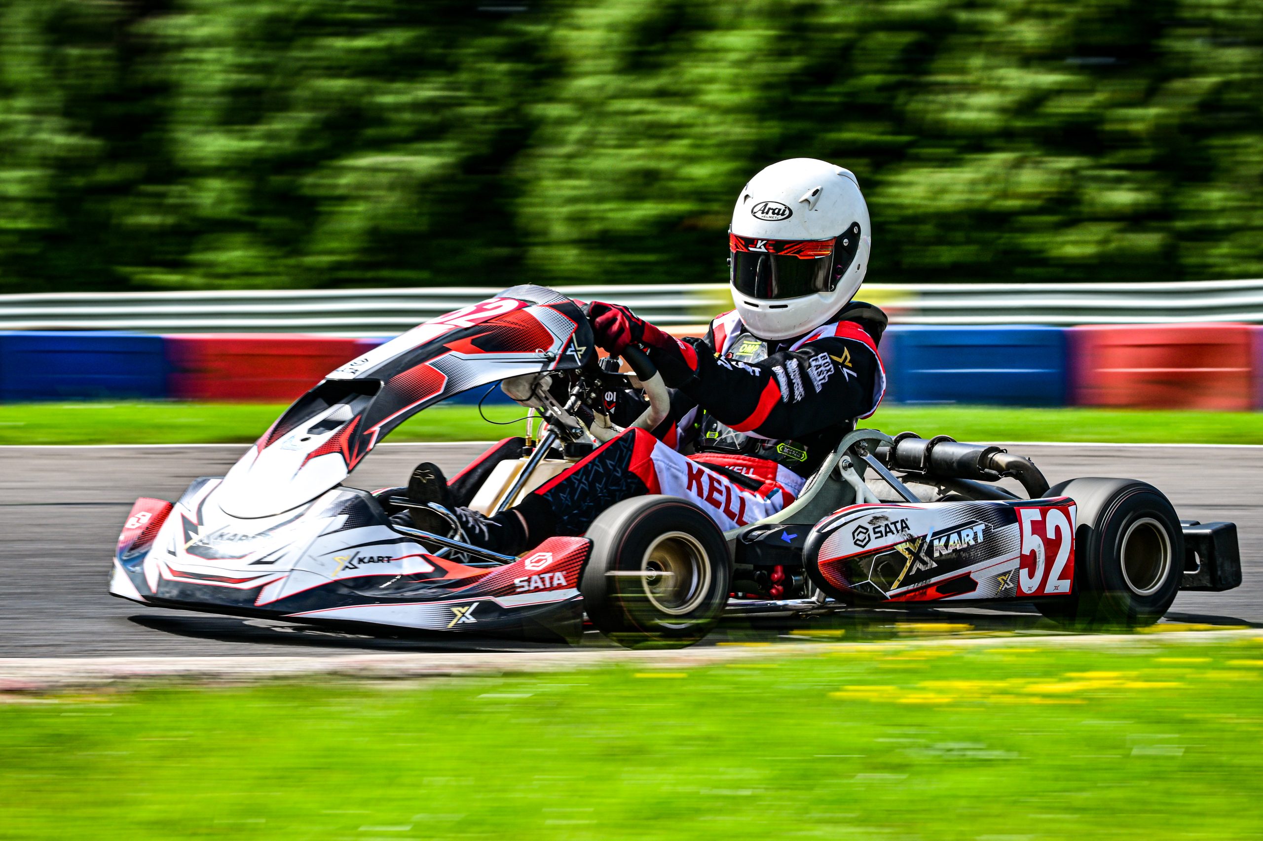 image of james kell motorsport at clay pigeon as apart of the 2023 kart championship with xkart following his scholarship win in a black red and white kart rotax number 52